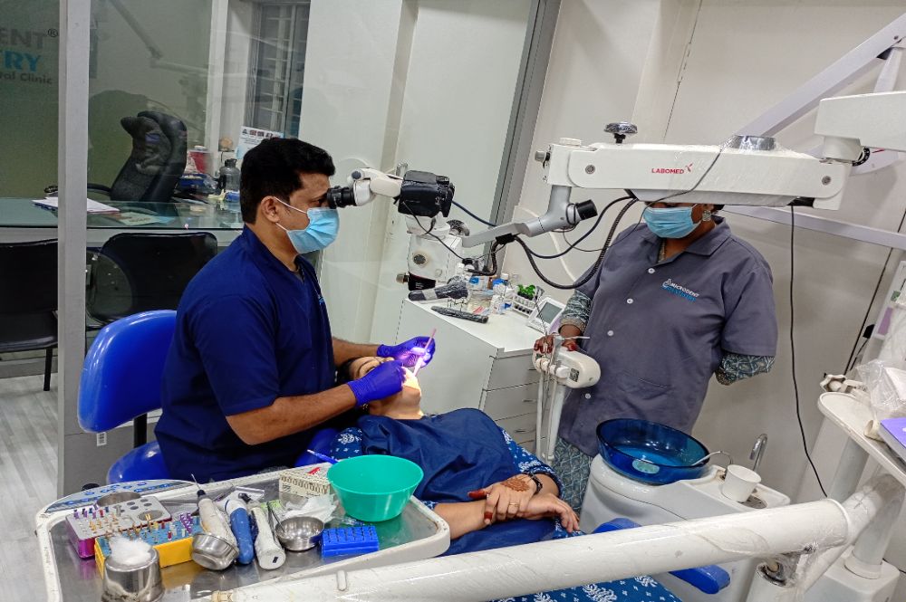 Dentist performing dental procedure on patient.